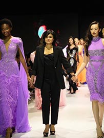 Designer and models presenting ballroom costumes